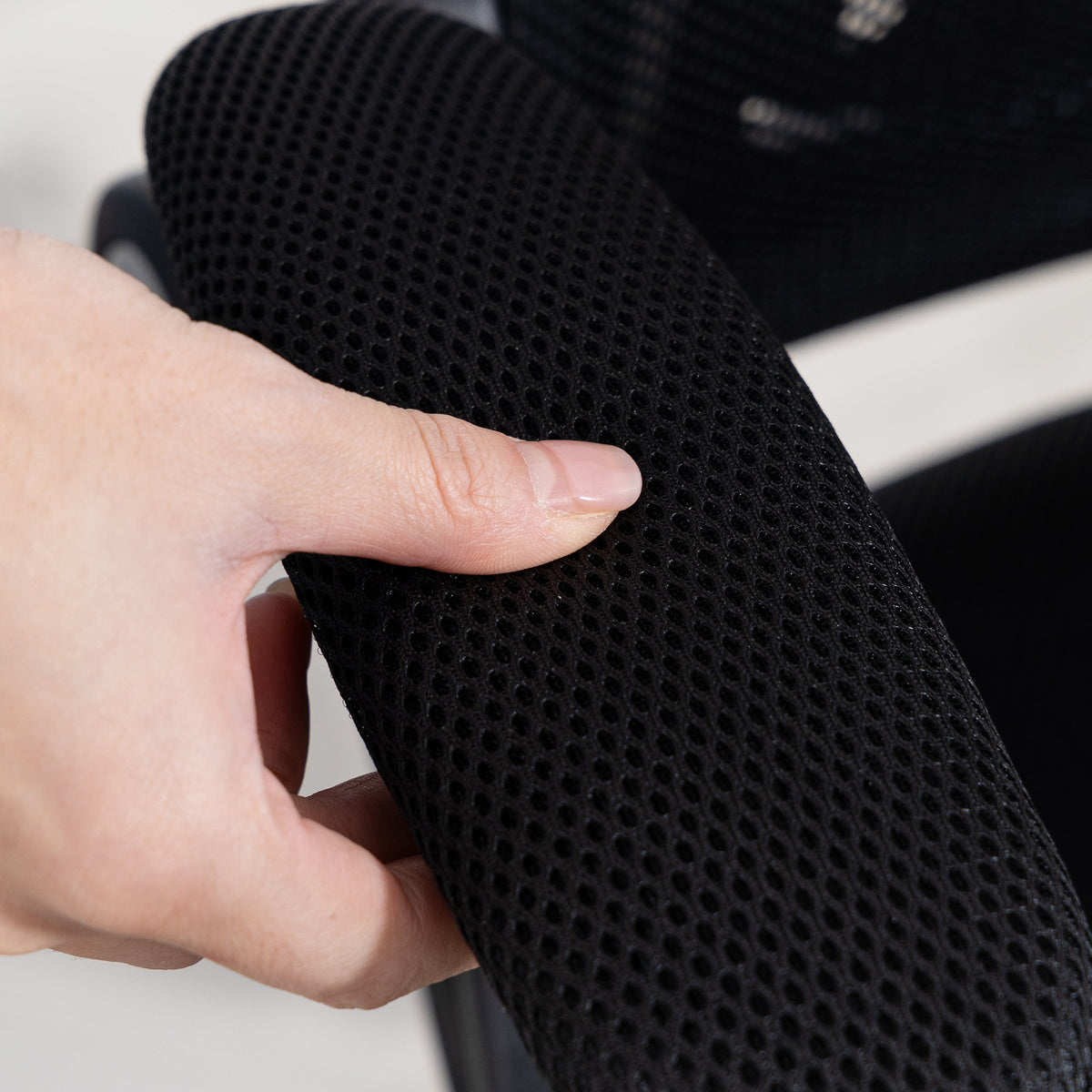 Black ergonomic mesh office chair with lift-up armrests