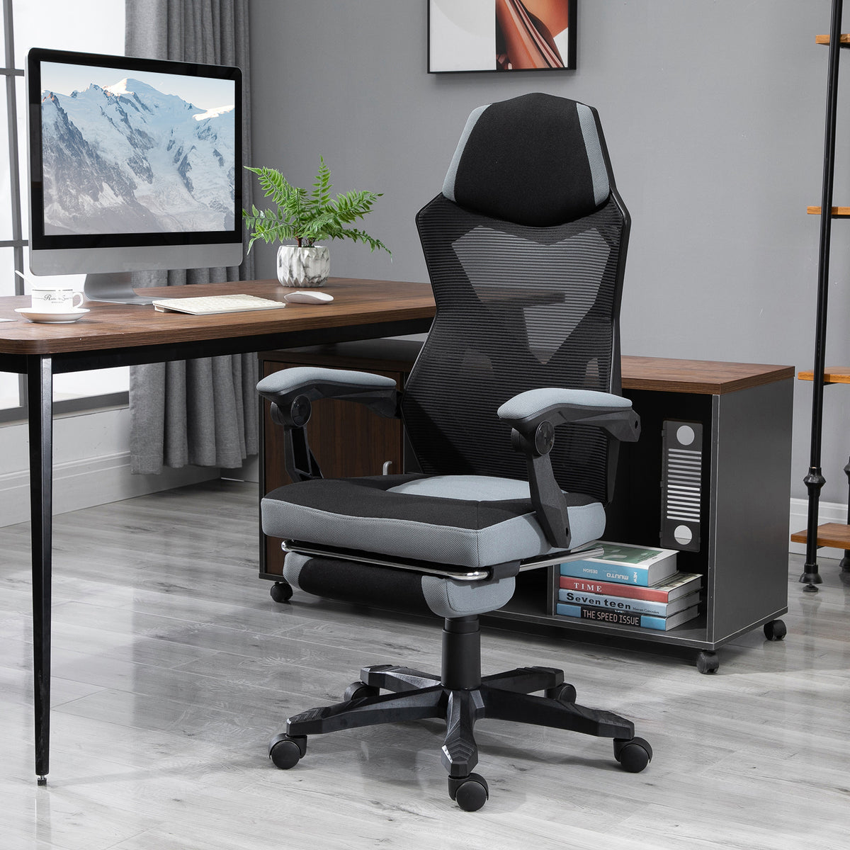 Mesh office chair reclined with footrest pulled out