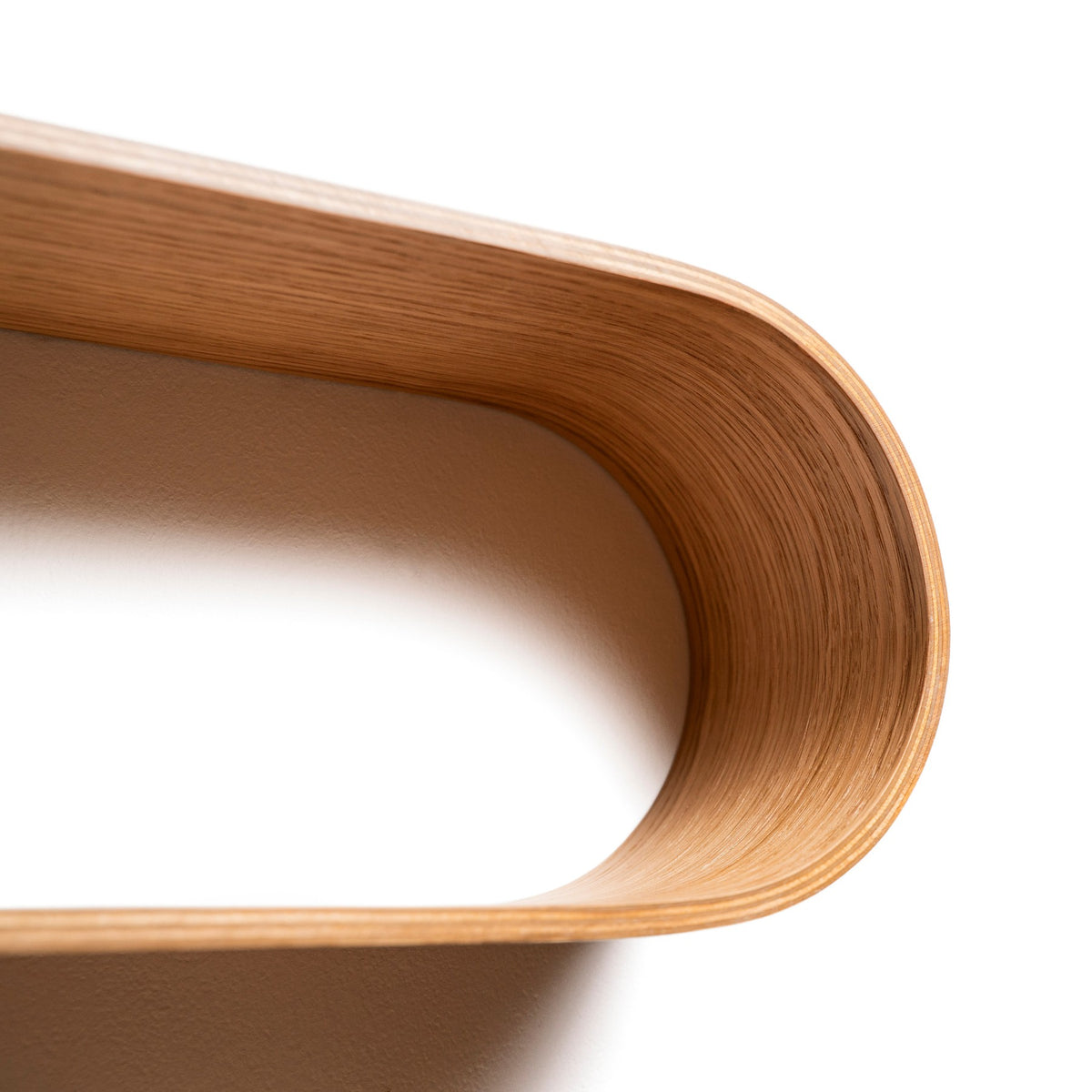 Close-up of the curved birch plywood on the Snake floating shelf