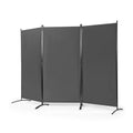 Foldable room divider screen separating a desk area from a living room