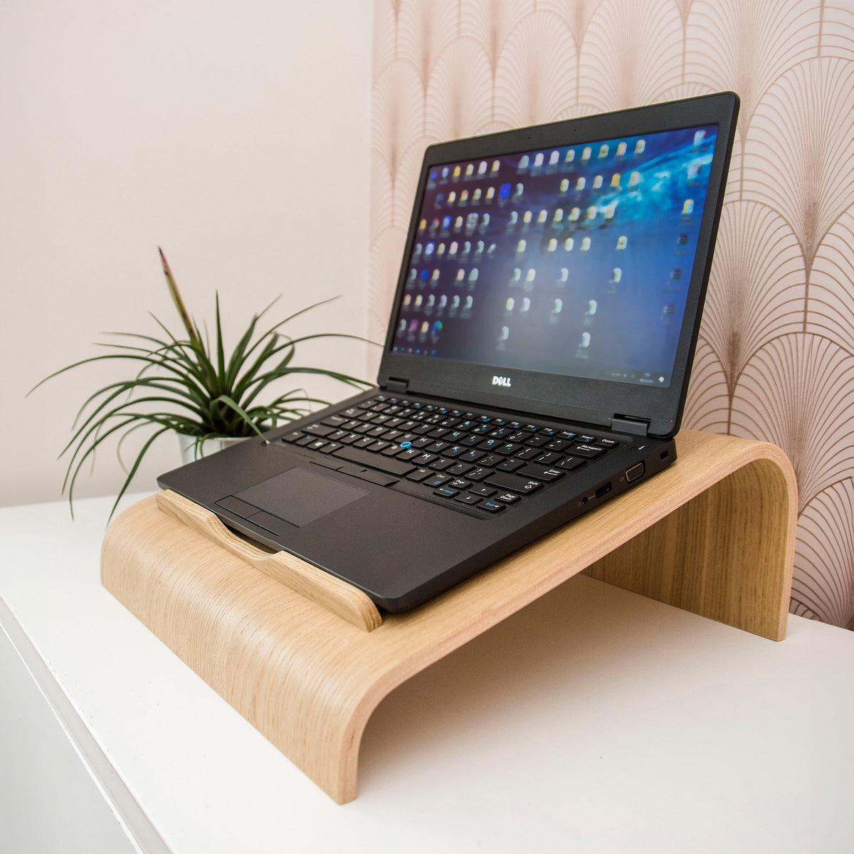 Natural wood vented laptop stand on a desk